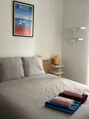 a bedroom with a bed with two towels on it at Bel appartement au calme hyper centre Nice in Nice