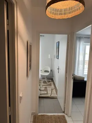a hallway leading into a living room with a chandelier at Bel appartement au calme hyper centre Nice in Nice