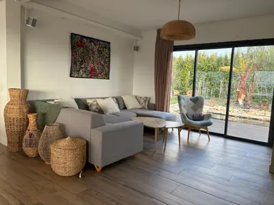 a living room with a couch and a table and chairs at Luxury villa piscine chauffée confort exceptionnel in Nice