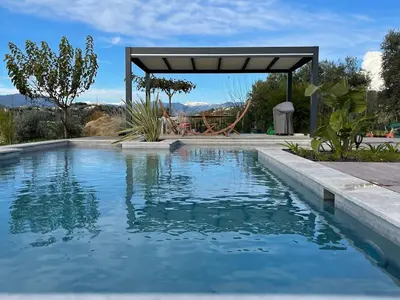 a swimming pool with a playground in the background at Luxury villa piscine chauffée confort exceptionnel in Nice