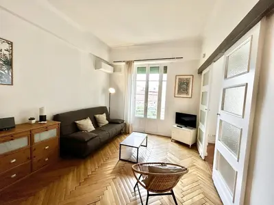 a living room with a couch and a table at B G La Residence Grimaldi Promenade des Anglais in Nice