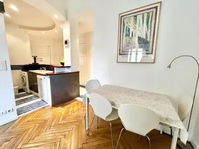 a kitchen and dining room with a table and chairs at B G La Residence Grimaldi Promenade des Anglais in Nice