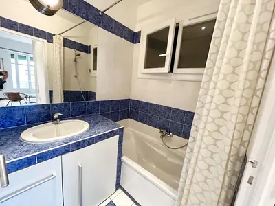 a bathroom with a sink and a bath tub at B G La Residence Grimaldi Promenade des Anglais in Nice