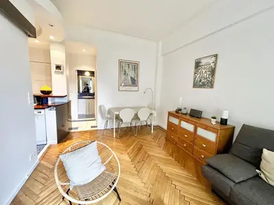 a living room with a couch and a table at B G La Residence Grimaldi Promenade des Anglais in Nice