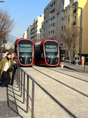 two red trains on the tracks in a city at Appartement Nice Magnan promenade in Nice