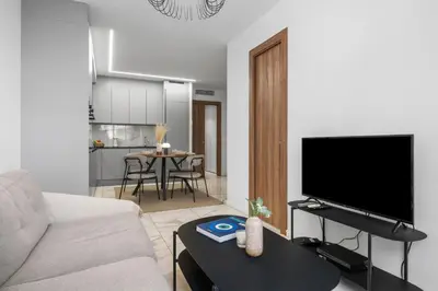 a living room with a couch and a flat screen tv at Nice - Mordern Apartment Sea Close in Nice