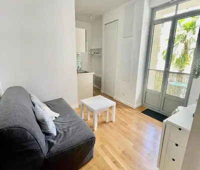 a living room with a couch and a table at Nice two-rooms with balcony in Nice in Nice