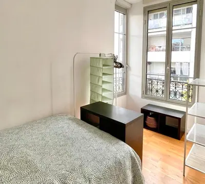 a bedroom with a bed and a desk and windows at Nice two-rooms with balcony in Nice in Nice