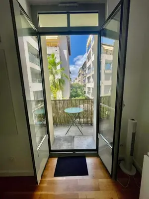 a glass door leading to a balcony with a table at Nice two-rooms with balcony in Nice in Nice