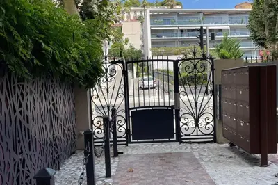 a black gate with a door in a building at Nice two-rooms with balcony in Nice in Nice