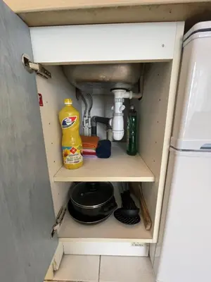 a cupboard in a kitchen with a sink and some food at Cœur de Nice in Nice