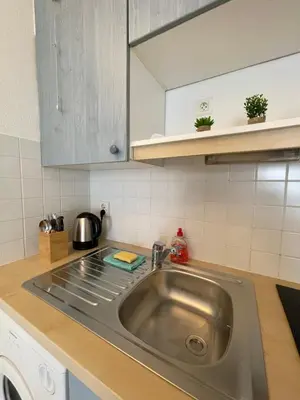a kitchen with a sink and a counter top at Cœur de Nice in Nice