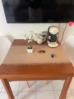 a table with a coffee maker and flowers on it at Cœur de Nice in Nice