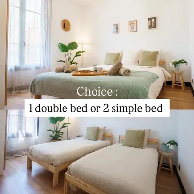 a bedroom with two beds and a table at Magnifique Appartement 3P in Nice