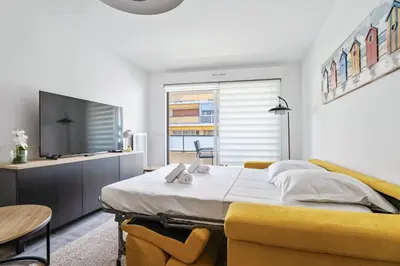 a bedroom with a bed and a flat screen tv at Appartement Amandiers - Welkeys in Cagnes-sur-Mer