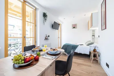 a kitchen and living room with a table with fruit on it at MY CASA - BUFFA 3-53 - Superb Studio Suite City Center in Nice