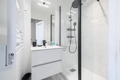 a white bathroom with a shower and a sink at MY CASA - BUFFA 3-53 - Superb Studio Suite City Center in Nice