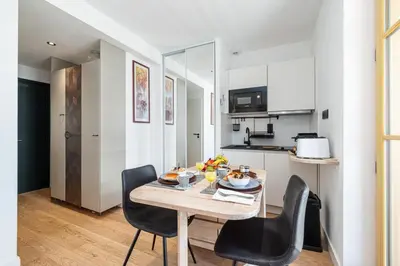 a kitchen and dining room with a table and chairs at MY CASA - BUFFA 3-53 - Superb Studio Suite City Center in Nice