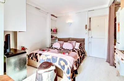 a bedroom with a bed and a tv in it at Nice - Little Studio with Sunny Terrace in Nice