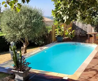 a large blue swimming pool in a yard at Villa Provençale in Gattières