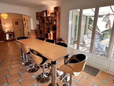 a wooden shelf with glass bottles and a vase on it at Villa Provençale in Gattières