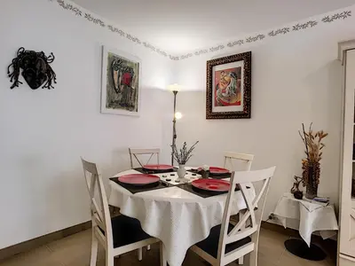 a dining room with a white table and chairs at Nestor&Jeeves - VILLA HARMONIE TERRASSE - Central - Free parking in Nice