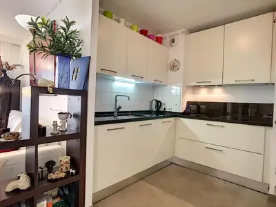a kitchen with white cabinets and a sink at Nestor&Jeeves - VILLA HARMONIE TERRASSE - Central - Free parking in Nice