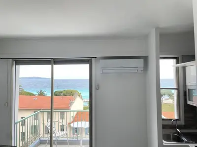 a living room with a view of the ocean at STUDIO EN FACE DE LA PLAGE AVEC une VUE FANTASTIQUE ! in Nice
