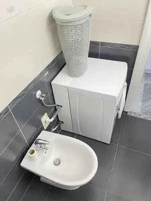 a bathroom with a white sink and a trash can at STUDIO EN FACE DE LA PLAGE AVEC une VUE FANTASTIQUE ! in Nice