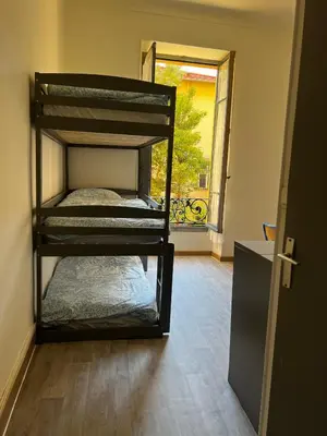 a room with two bunk beds in a room at Alpazur in Nice