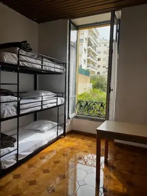 a room with three bunk beds and a window at Alpazur in Nice