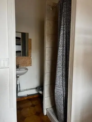 a bathroom with a shower curtain and a sink at Alpazur in Nice