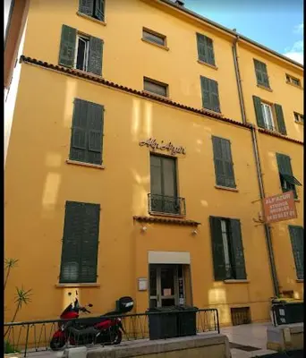 a building with a motorcycle parked in front of it at Alpazur in Nice