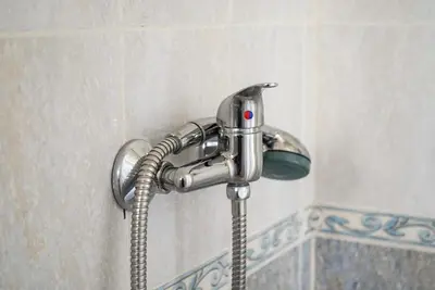 a shower head with a hose in a bathroom at Alpazur in Nice