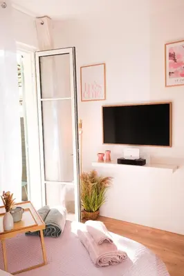 a living room with a mirror and a tv at Casa Luna in Nice