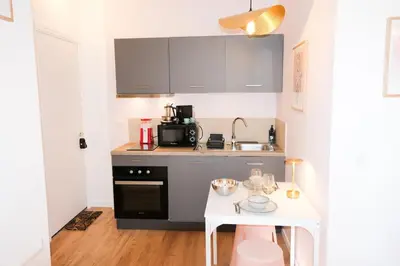 a small kitchen with a white table and a counter at Casa Luna in Nice
