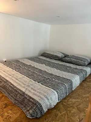 a bed in a room with two pillows on it at Nice Cosy in Nice