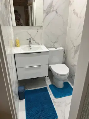 a white bathroom with a sink and a toilet at Nice Cosy in Nice