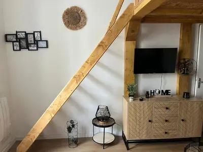 a living room with a tv and a dresser with at Nice Cosy in Nice