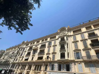 a large white building with windows and a blue sky at Beautiful studio with parking place Massena in Nice