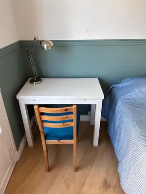 a desk with a lamp and a chair next to a bed at Shared flat in Liberation in Nice
