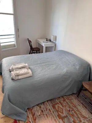 a bedroom with a bed with two towels on it at Shared flat in Liberation in Nice