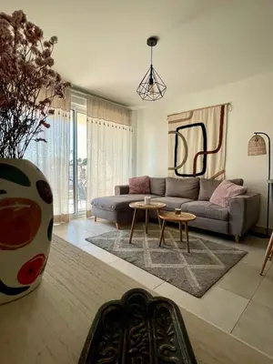 a living room with a couch and a table at Appartement 2P Cros de Cagnes à 2 pas de la mer in Cagnes-sur-Mer