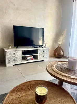 a living room with a couch and a table at Appartement 2P Cros de Cagnes à 2 pas de la mer in Cagnes-sur-Mer