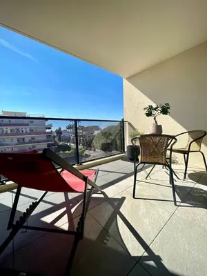 a balcony with a table and chairs and a view at Appartement 2P Cros de Cagnes à 2 pas de la mer in Cagnes-sur-Mer