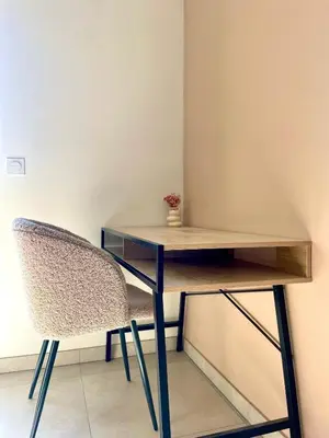 a living room with two tables and a tv at Appartement 2P Cros de Cagnes à 2 pas de la mer in Cagnes-sur-Mer