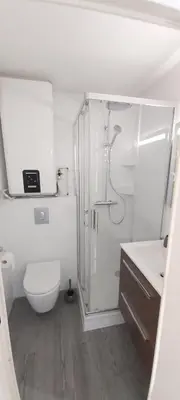 a white bathroom with a shower and a toilet at Studio Cosy proche Carlone, balcon in Nice