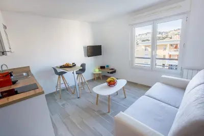 a living room with a couch and a table at Joli Studio proche Promenade des Anglais in Nice
