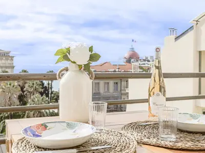 a table with a bottle of wine and a glass at Apartment Le Mirazur by Interhome in Nice