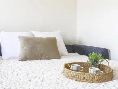 a bed with two baskets and two cups on it at Apartment Le Mirazur by Interhome in Nice